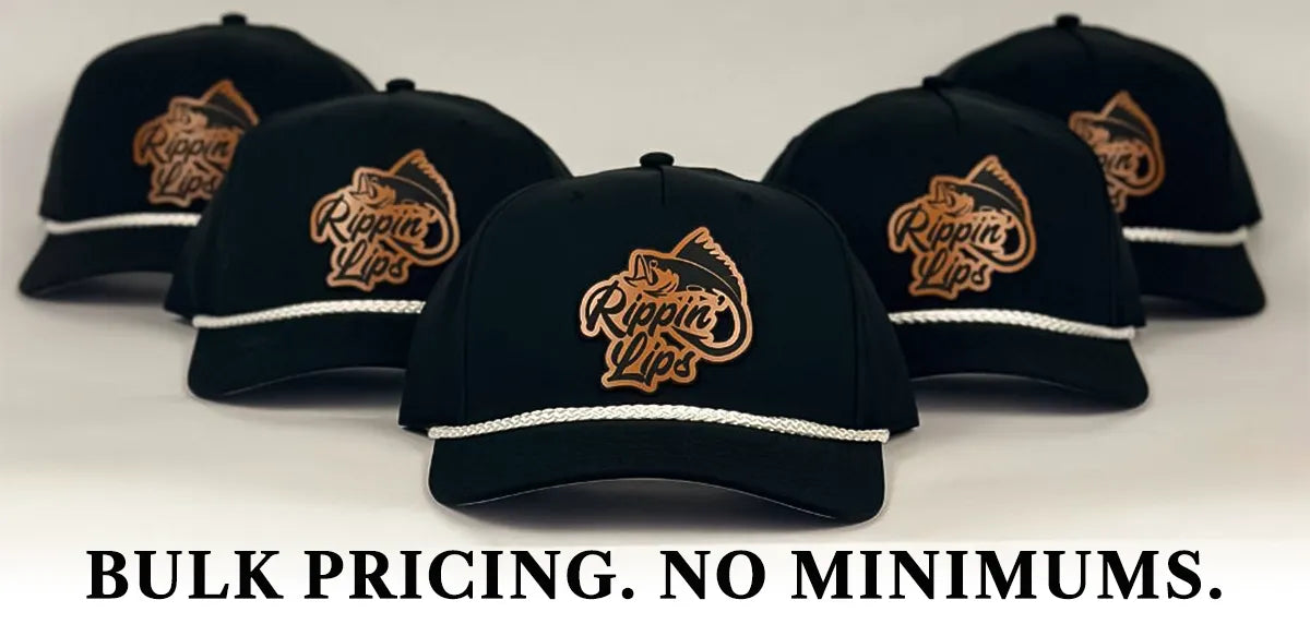 Group of five black Richardson 258 rope hats featuring brown 'Rippin’ Lips' fish logo patches and white braided rope detail, arranged on a white background with the text 'BULK PRICING. NO MINIMUMS.' below the caps.